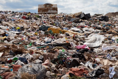 Segregated recycling bins and labelled waste streams at a commercial site
